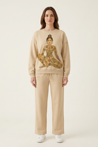 Brunette woman wearing the sweatshirt and pants set